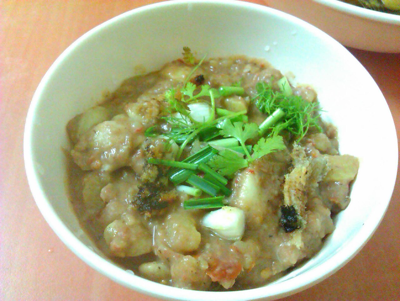A bowl of eromba, the Manipuri mashed chutney, made with yongchak (stink beans) and topped with herbs