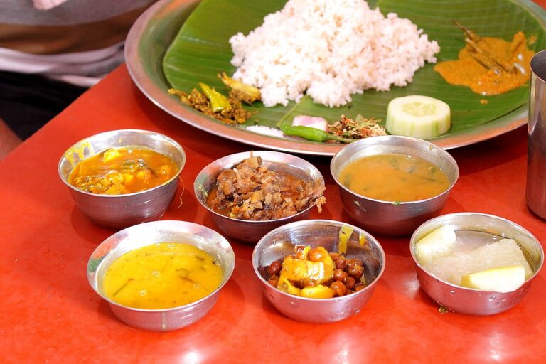 Ningol Chakouba food: a Manipuri thali of rice on banana leaf with eromba, ooti, fish and other side dishes